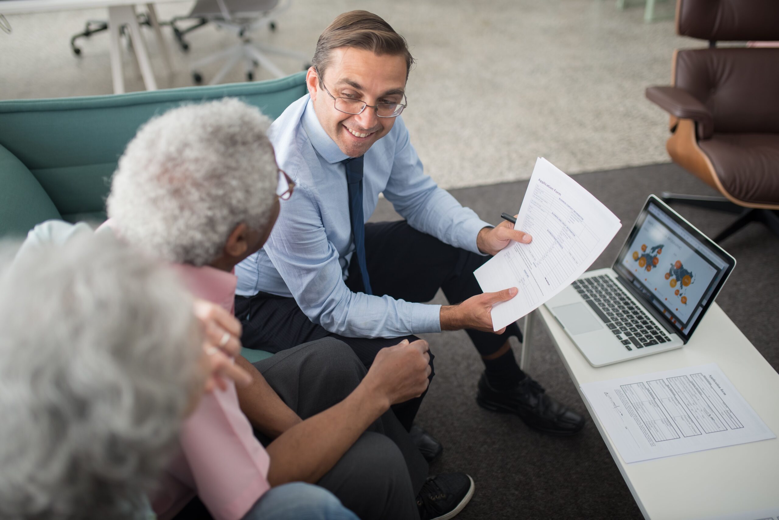 Older adult in their 70s discussing a long-term care insurance application with an advisor