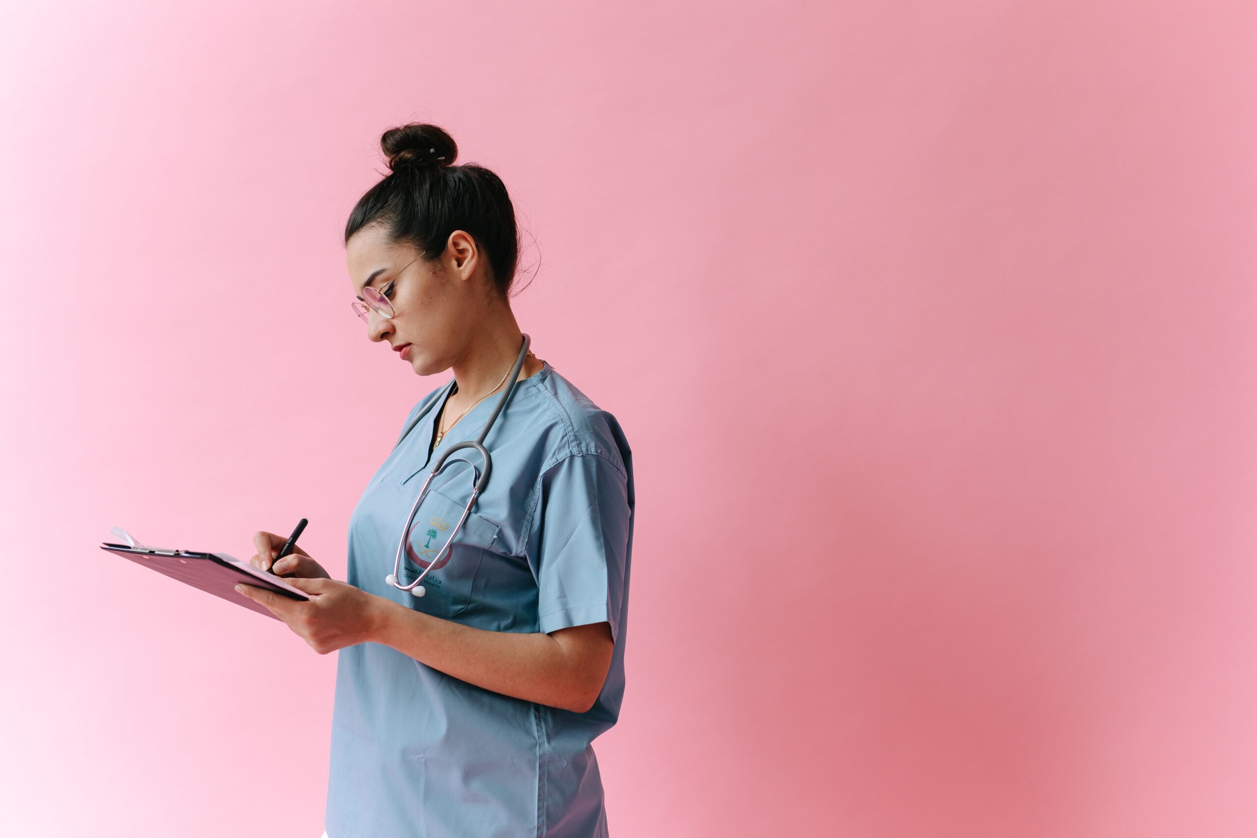 Healthcare professional taking notes during a long-term care insurance benefit assessment