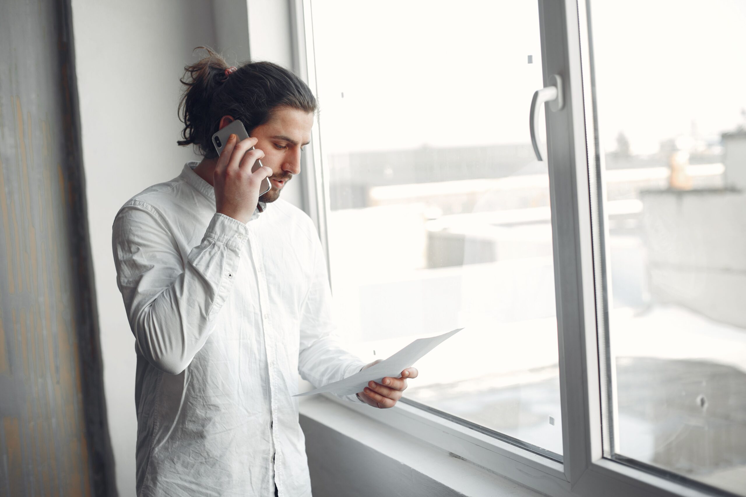 Adult on the phone with a licensed long-term care insurance agent comparing quotes from several carriers