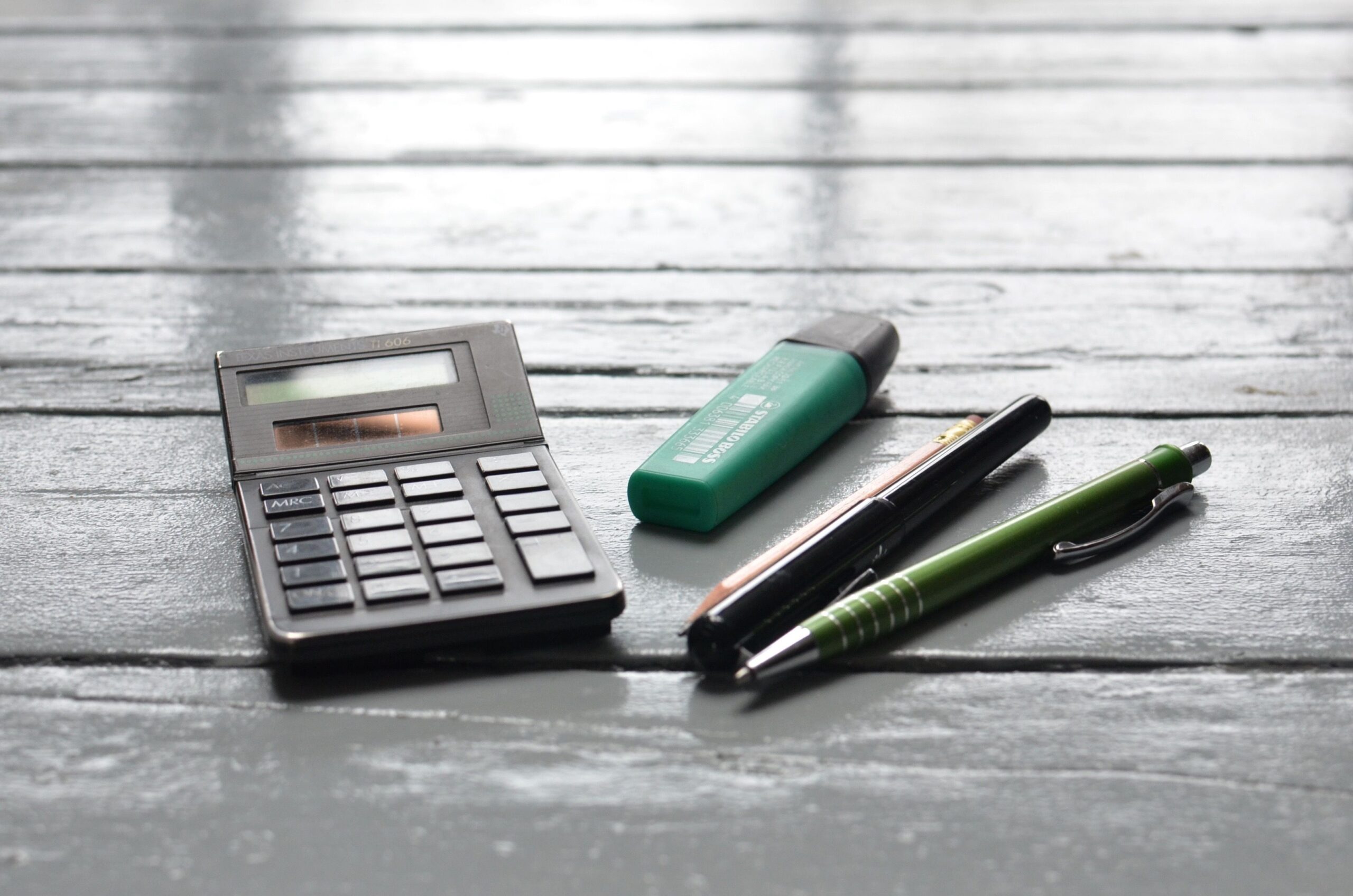 Calculator and care cost paperwork representing the gap between long-term care costs and insurance premiums