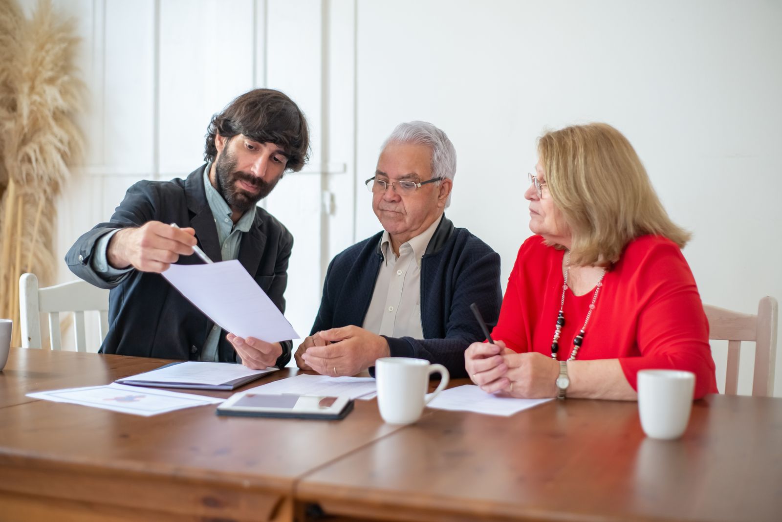 Couple comparing long-term care insurance quote options with an advisor