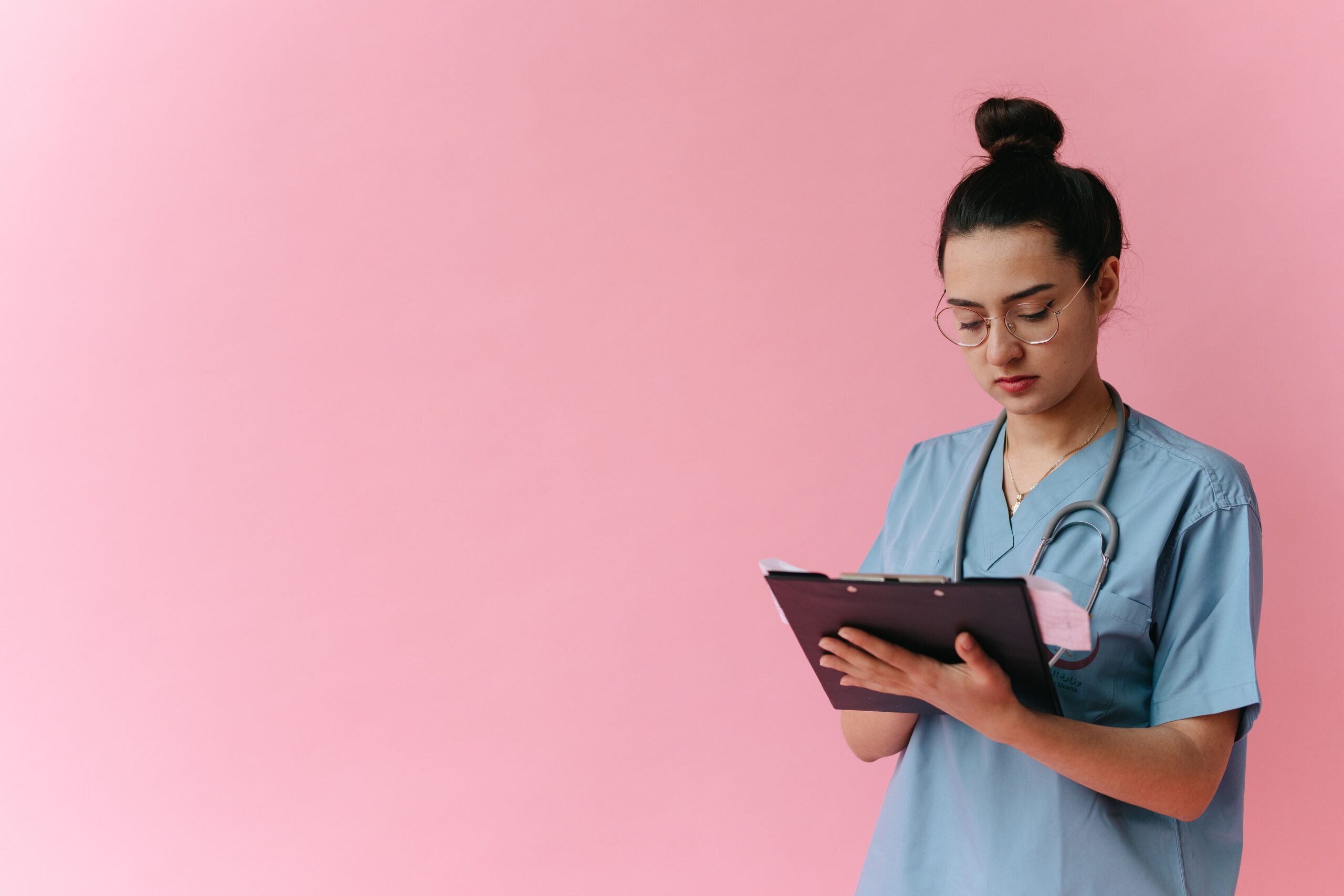 Healthcare professional reviewing notes on a clipboard, representing a long-term care insurance underwriting interview