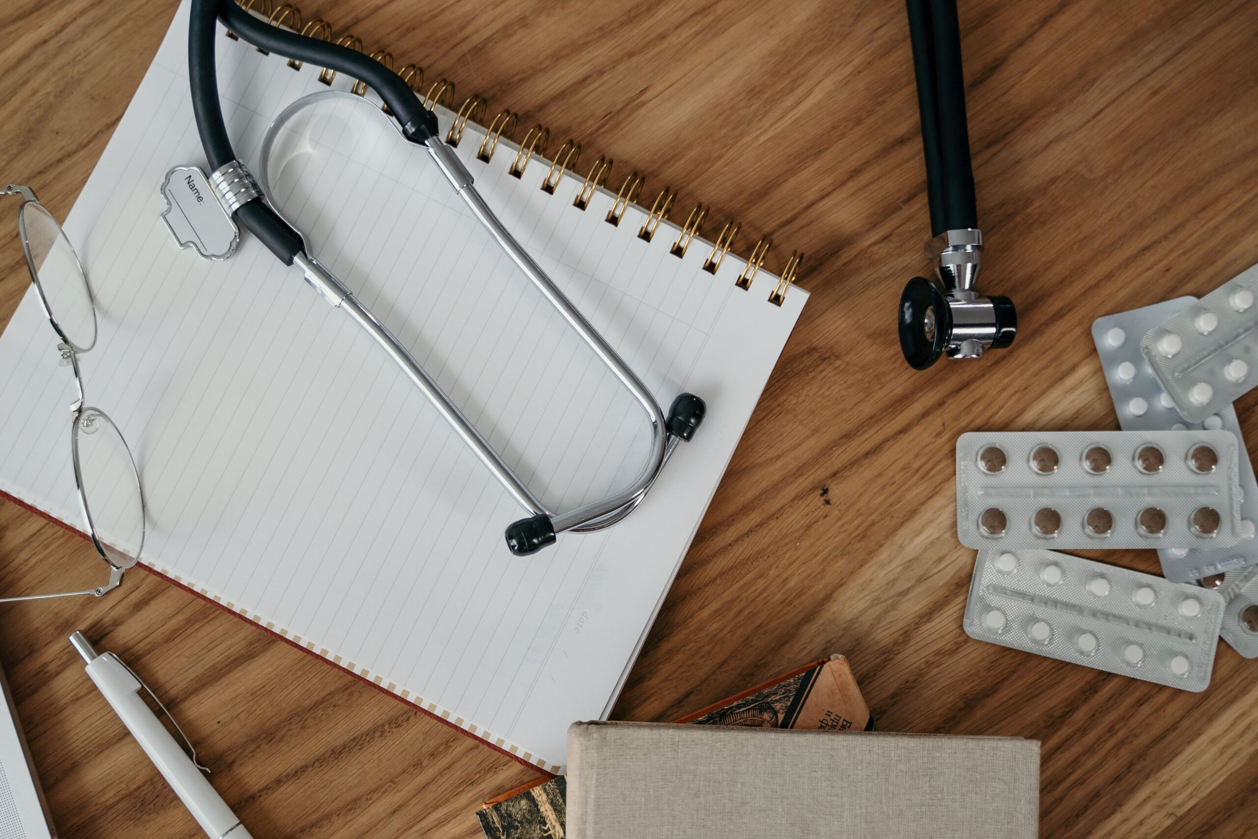 Stethoscope and notebook on a desk, representing long-term care insurance coverage details