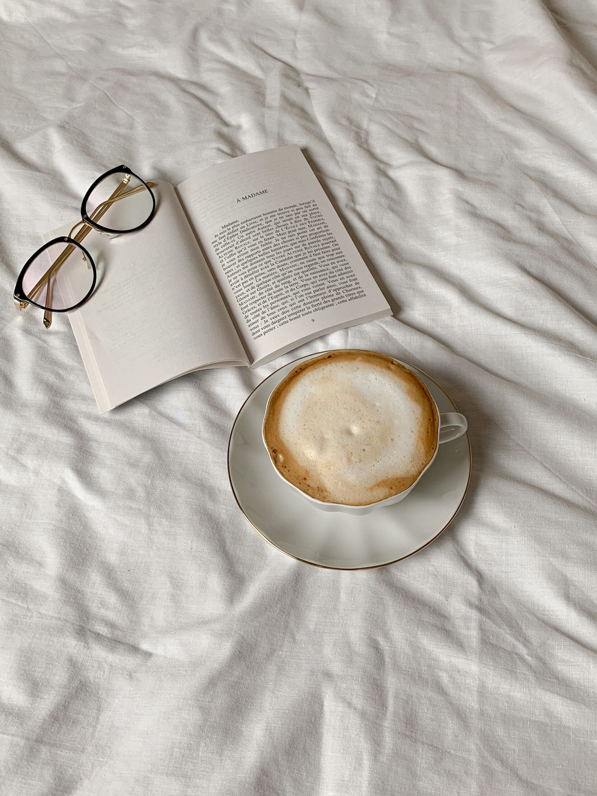 Open book with reading glasses on top, representing long-term care insurance guides and fundamentals